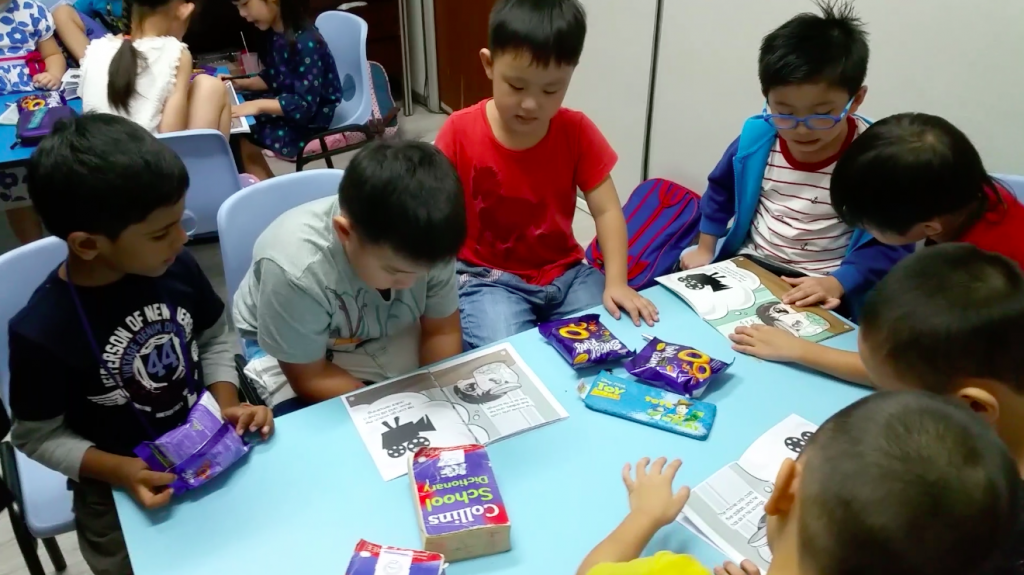 The kids reading about  "Let's Meet Committed Conrad" story