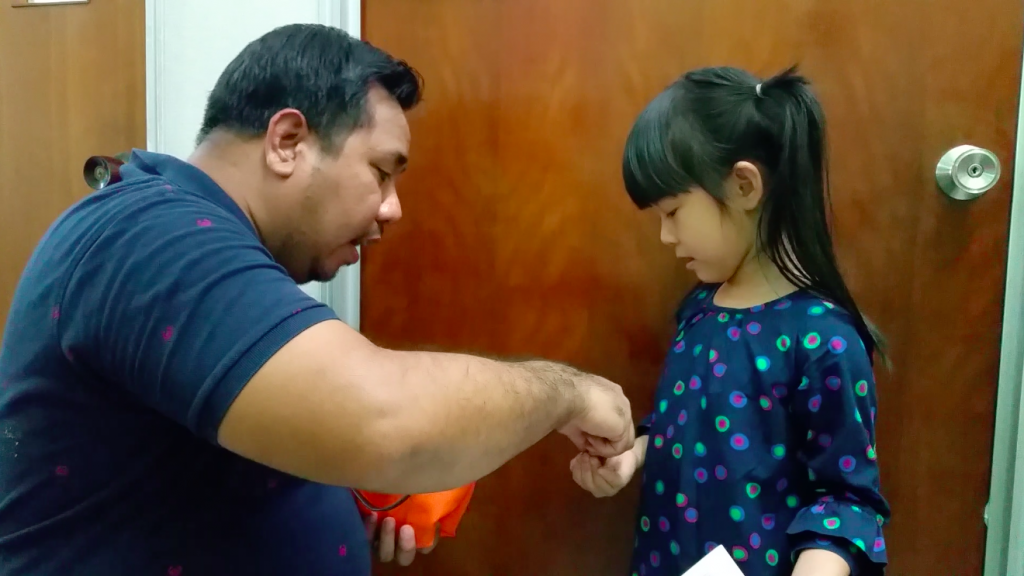 The kids receiving some money (cash in coins)
